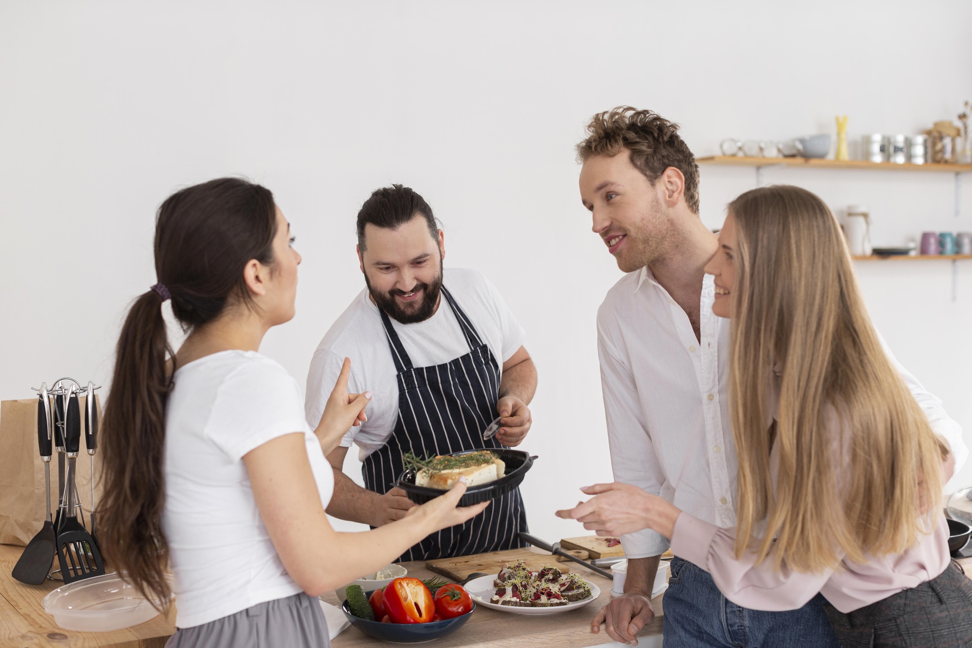 Workshop group cooking around a table
